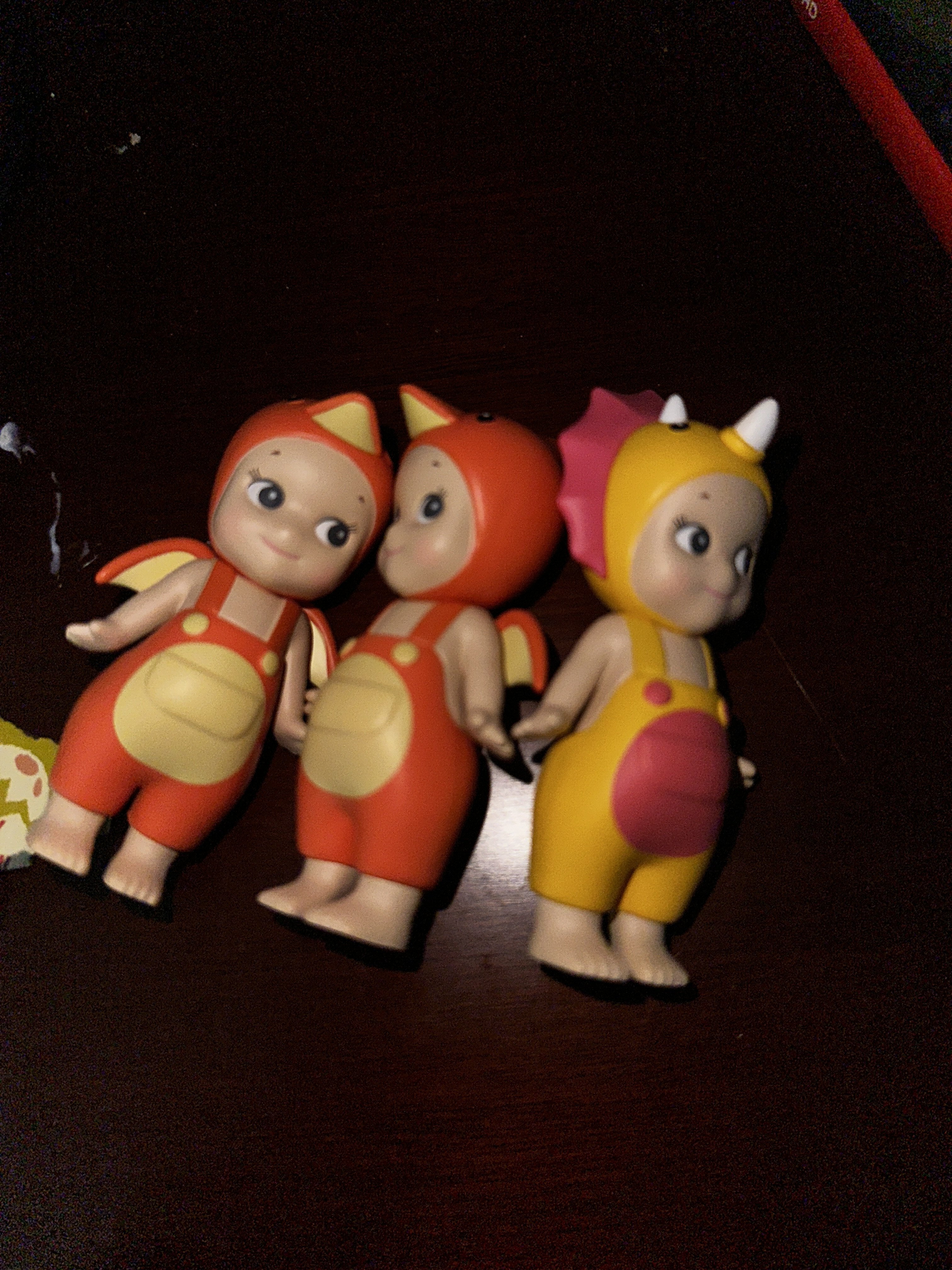 Charms layered on the desk before the swap meet.